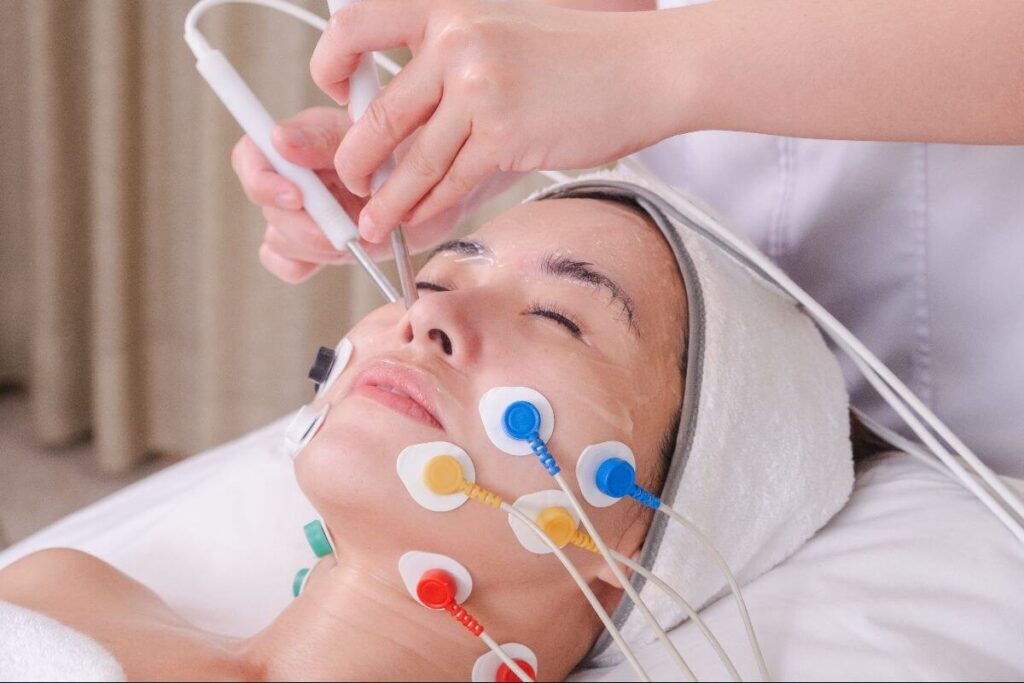 Client receives an anti-wrinkle facial treatment with electrode pads and skincare devices at Facial Care Centre